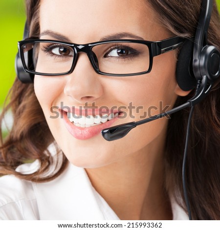 Portrait of happy smiling young support phone operator in headset