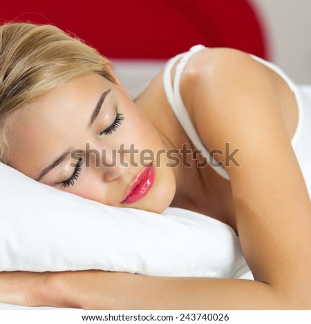 Beautiful young sleeping woman at bedroom