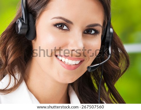 Portrait of happy smiling cheerful young businesswomen, support phone female operator or call center worker, in headset, looking at camera. Help and consulting concept.