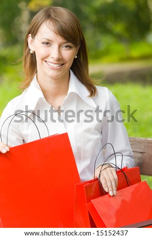 Young happy woman with shopping bags, outdoors