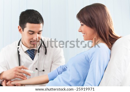 Happy doctor giving an injection to female patient