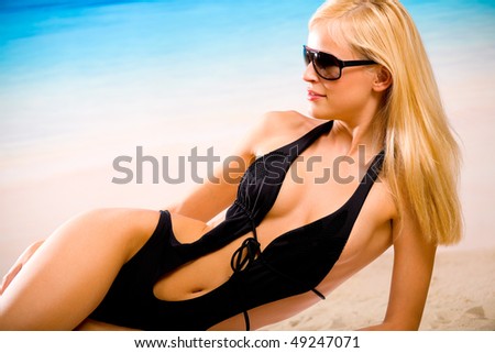 Tanned woman in bikini on the beach
