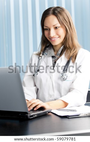 Happy doctor or nurse with laptop at office