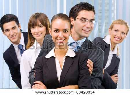 Funny portrait of happy smiling successful business team at office