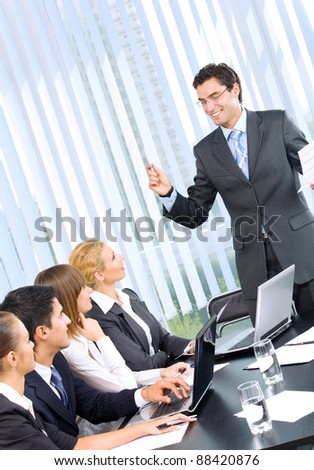 Young happy smiling successful businesspeople at meeting, presentation or conference