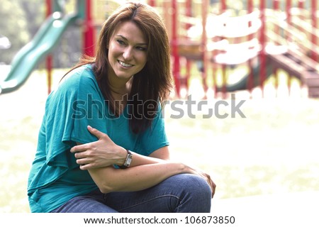 A beautiful brunette model posing in an outdoor environment