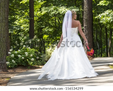 A modern bride posing in an outdoor environment