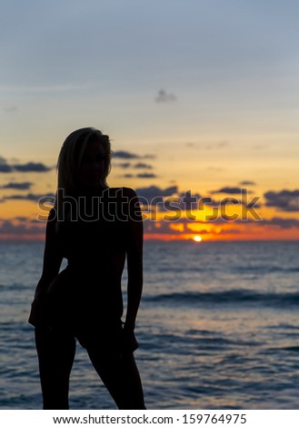 Silhouette of a model on a beach in the caribbean