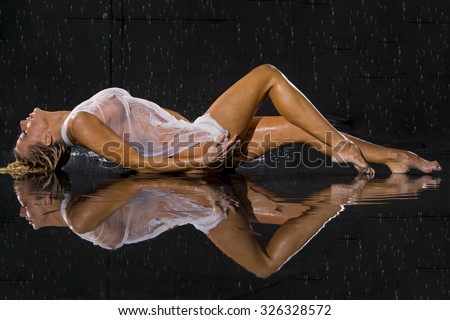 Model posing against a studio rain curtain