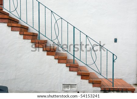 Closeup of concrete stairway with brick stairs and stucco walls
