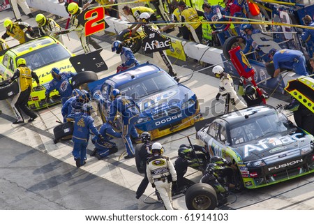 DOVER, DE - SEP 26:  Pit Road gets busy drivers bring their race cars in for service during the AAA 400 race at the Dover International Speedway in Dover, DE on Sep 26, 2010.
