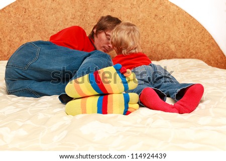 family lying in bed with touch pad, home leisure