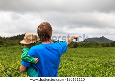 family looking at tea plantation field