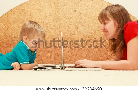 family with computer and touch pad at home