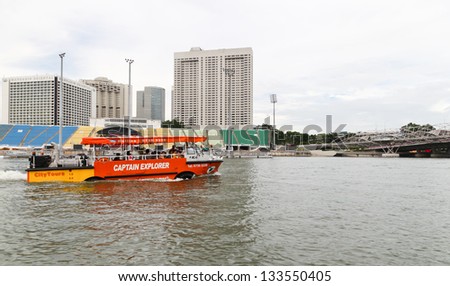 SINGAPORE -DECEMBER 27: A tourist boat moves along the river on December 27, 2012 in Singapore. The Singapore River Cruise is a tourist attraction in this former British colony.