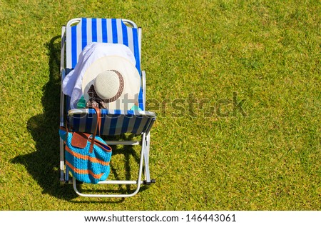 woman relaxed in lawn chair in the park