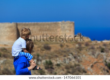 father and son looking at old fortress, travel background