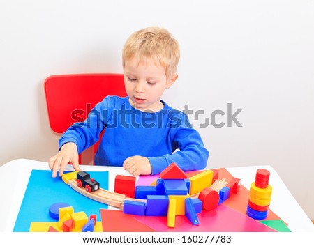 little boy playing with toys, early education and daycare concept
