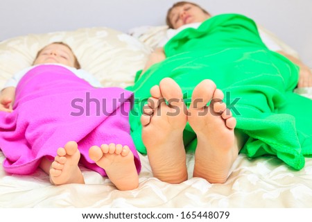 mother and son foot sleeping at home, home comfort