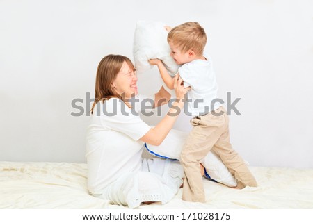 family having pillow fight in a bedroom, family leisure