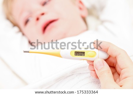 Fever, measuring temperature for little boy