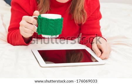Home work, young woman with cup of coffee and touch pad