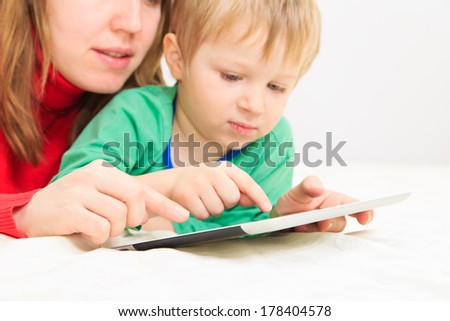 mother and son with touch pad at home, family leisure