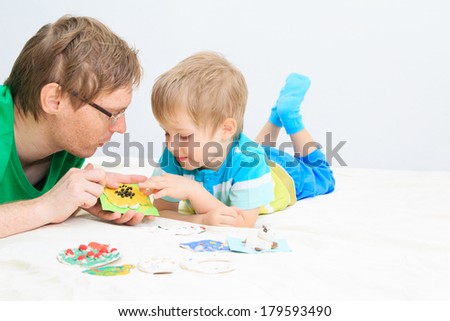 father and son looking at baby crafts, early education