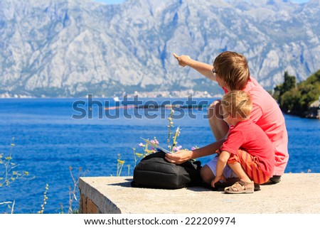 father and son looking at map on mountains vacation