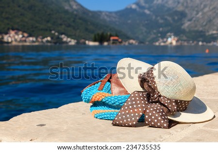 hat and beach bag near the sea in Montenegro, vacation concept