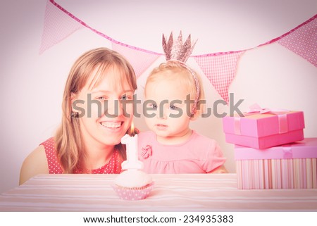 mother and happy little girl at first birthday party
