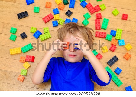 child playing with colorful plastic blocks indoor, early learning