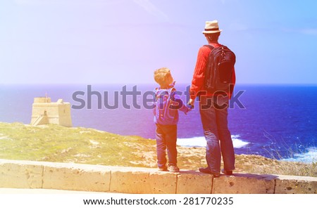 father and son looking at scenic view, family travel