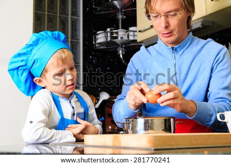 father and son cooking in kitchen interior