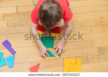 little boy playing with puzzle, early education concept