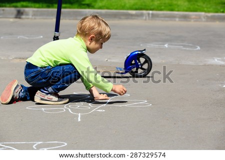 little boy drawing plane on asphalt, kids outdoor activities