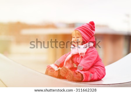 cute little girl enjoy first snow in the city, winter kids fun