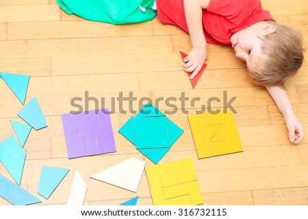 little boy playing with puzzle, early education concept