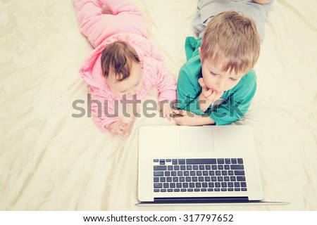 kids looking at laptop, early education and modern technology
