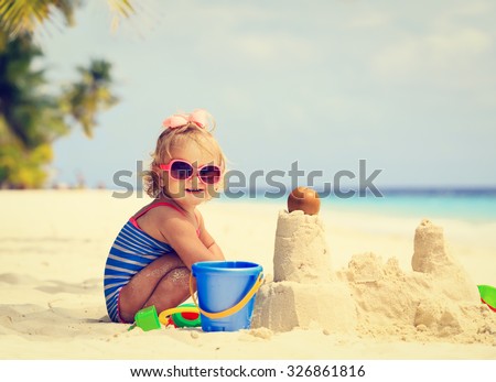 Image, Stock Photo Little girl building sand castle on beach