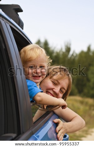 Baby with mother looking through car window