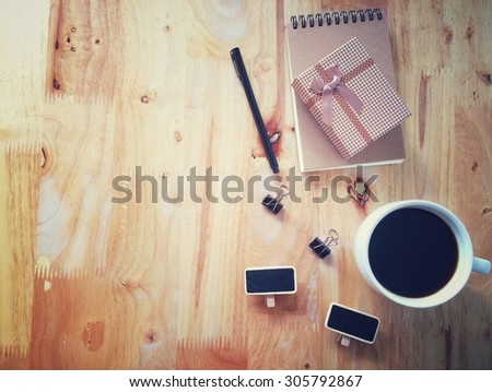 Top view of coffee and stationery mock up set with coffee, paper clip, notebook, small board  and pen also space for text