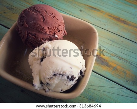 chocolate and cookie and cream ice cream scoop in a cup with retro filter effect