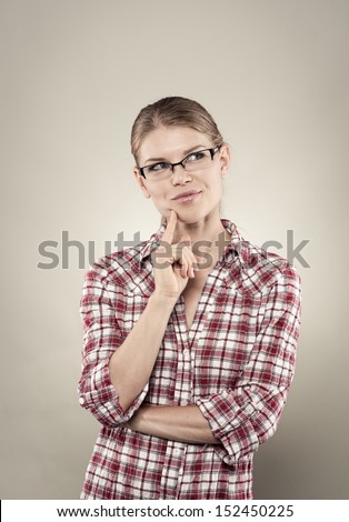 Business woman have an idea. Beautiful Caucasian pensive female model posing in studio.