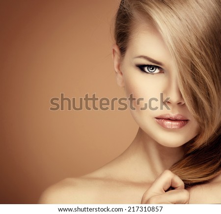 Stunning young Caucasian blond model showing her shiny long straight hair.