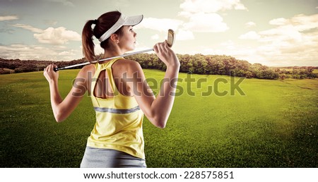 Golf woman standing with club looking ahead for shooting. Young female player on green field at summer.