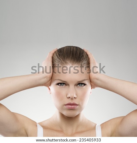 Portrait of woman touching her painful temples with copy space. Neurology. Brain disease. Insomnia concept.