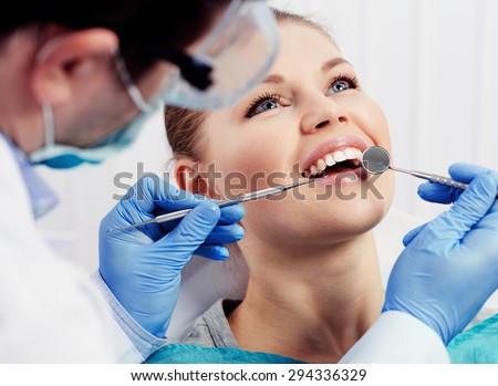 Caries protection. Tooth decay treatment. Female patient at dentist office curing teeth.