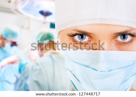 Close-up of a female surgeon with his team in operation room