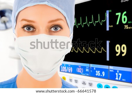 young female doctor in intensive care unit with ECG monitor